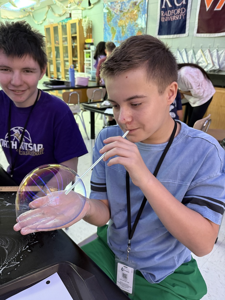 student blowing a bubble in his hand