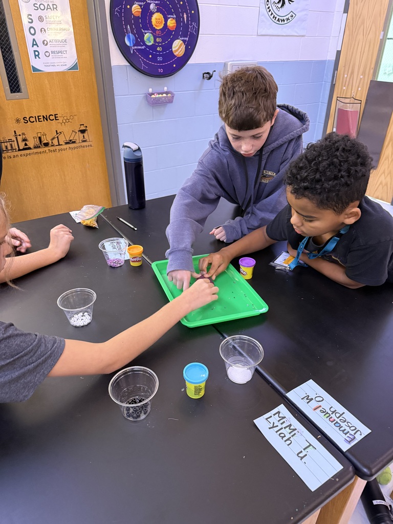 students selecting items from a tray to create the item they need