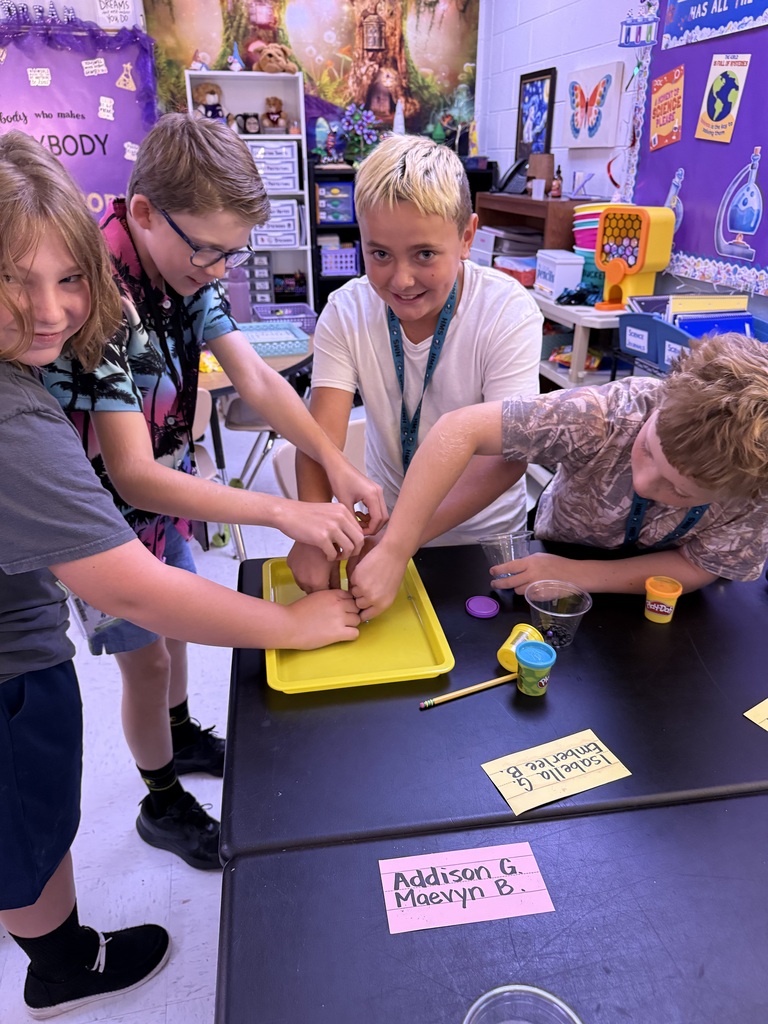 students engaged and smiling while they create their item for science review