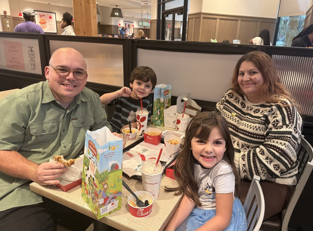 Family eating chick-fil-a attending school spirit night