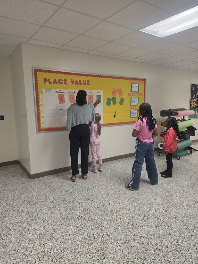 teacher assists as student writes number in expanded form