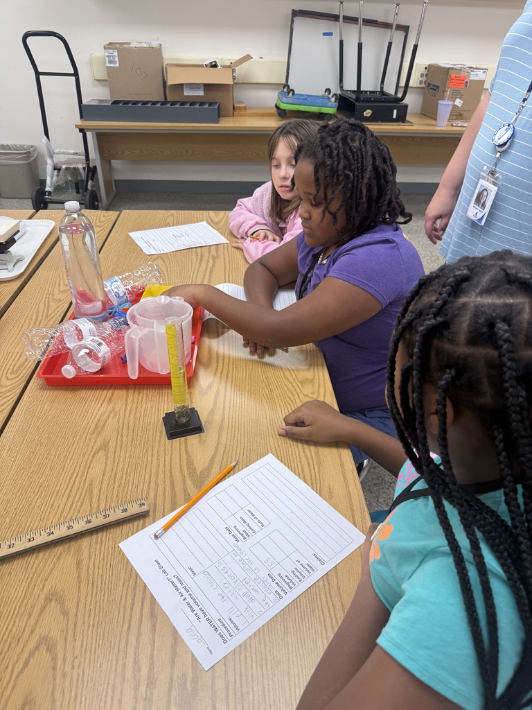 Group of students using science materials for their lab.