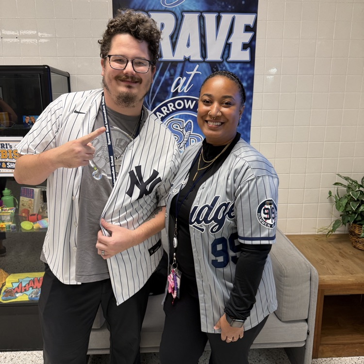 two staff members with jerseys 