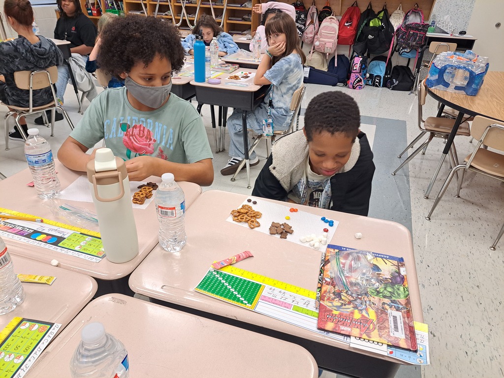 Two students working sorting different materials based on physical properties.