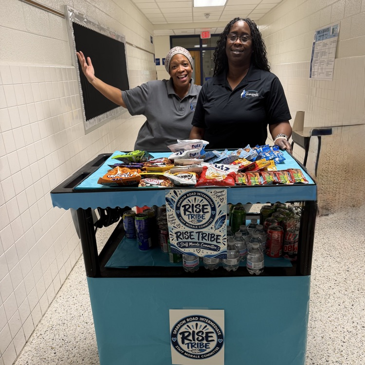 Staff with the RISE tribe cart filled with snacks and drinks. 