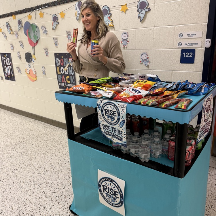 Staff with the RISE tribe cart filled with snacks and drinks. 