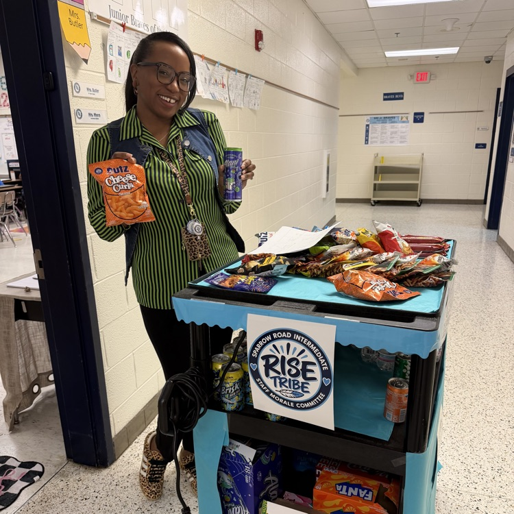 Staff with the RISE tribe cart filled with snacks and drinks. 