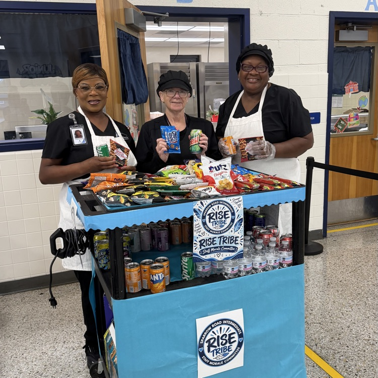 Staff with the RISE tribe cart filled with snacks and drinks. 