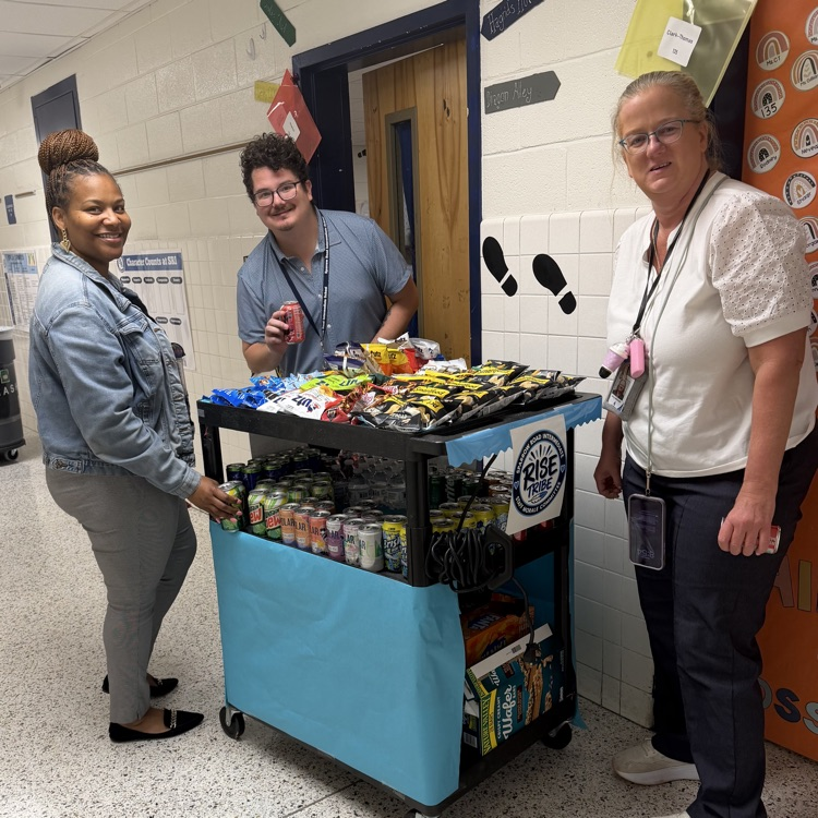 Staff with the RISE tribe cart filled with snacks and drinks. 