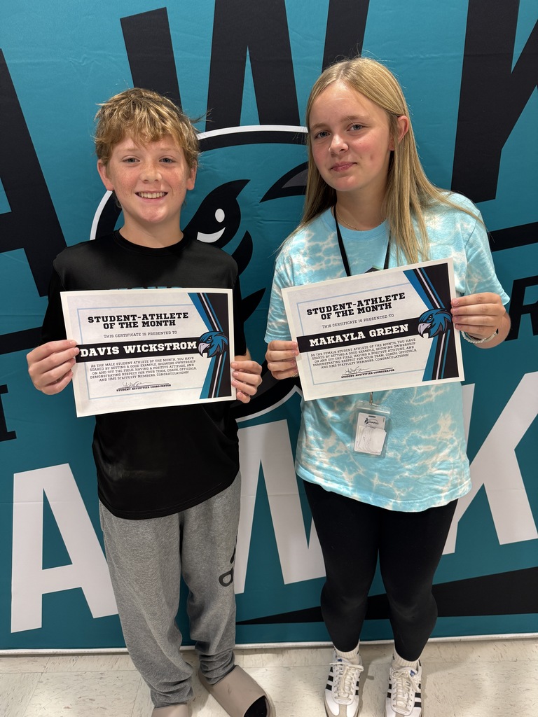 two students proudly holding their certificates