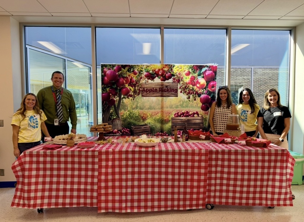 Mr. Mason with the PTA in front of the Apple themed treat table