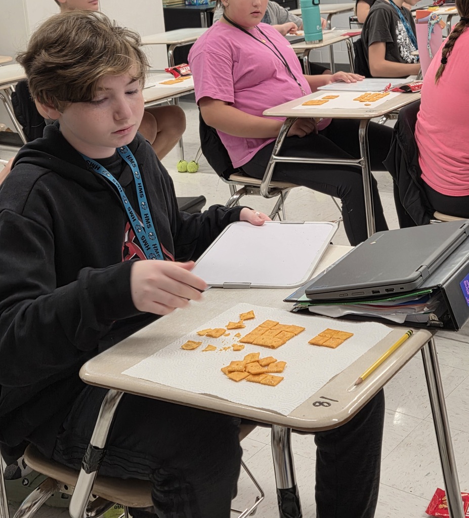 student arranging the cheese-its on his desk
