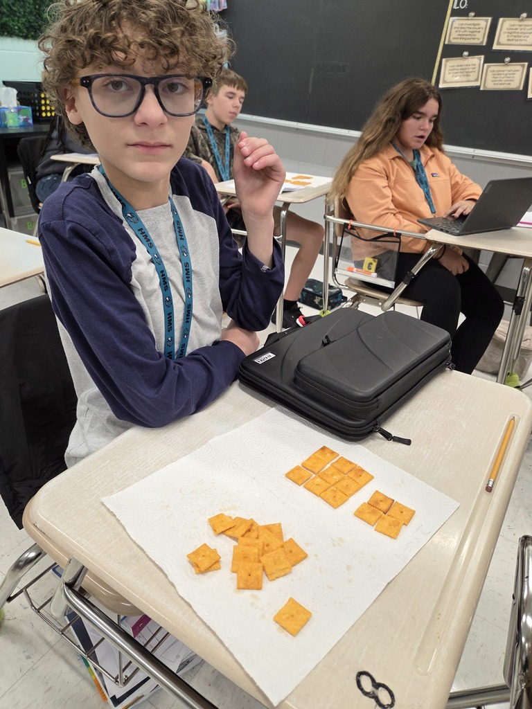 student arranging the cheese-its on his desk