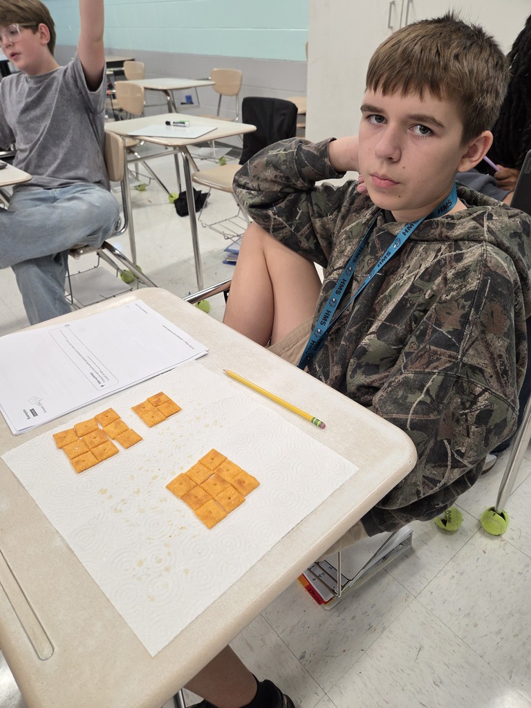 student arranging the cheese-its on his desk