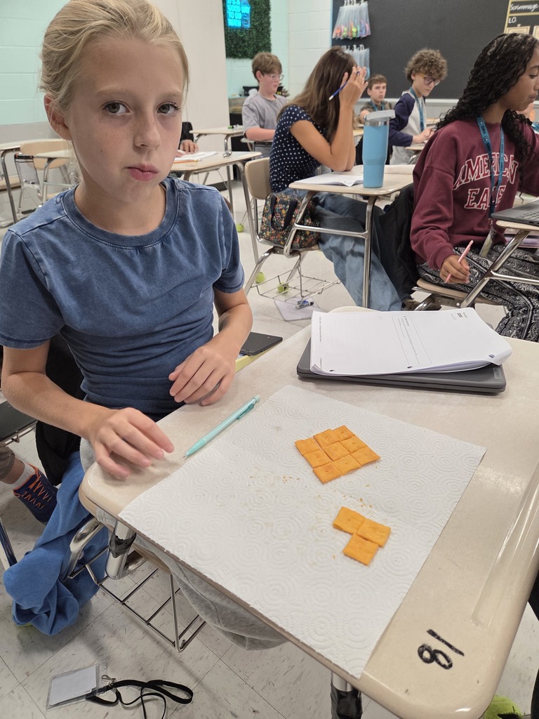 student looking puzzled while arranging the cheese-its on his desk