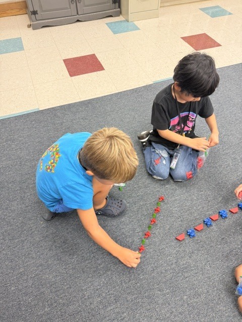 students creating patterns with manipulatives