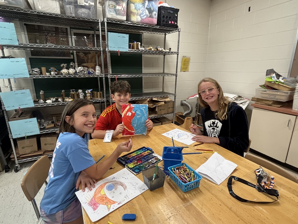 A 5th grade student works on a detailed Sun and Moon design in preparation for creating a clay sculpture.