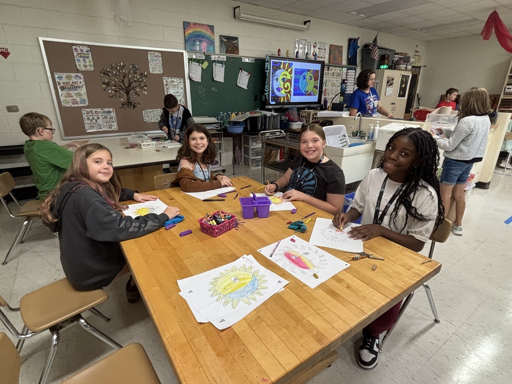 A 5th grade student works on a detailed Sun and Moon design in preparation for creating a clay sculpture.