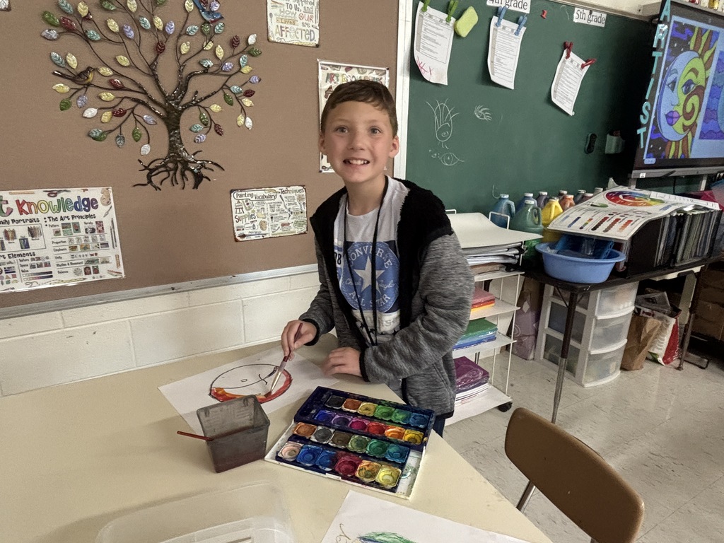 A 5th grade student works on a detailed Sun and Moon design in preparation for creating a clay sculpture.