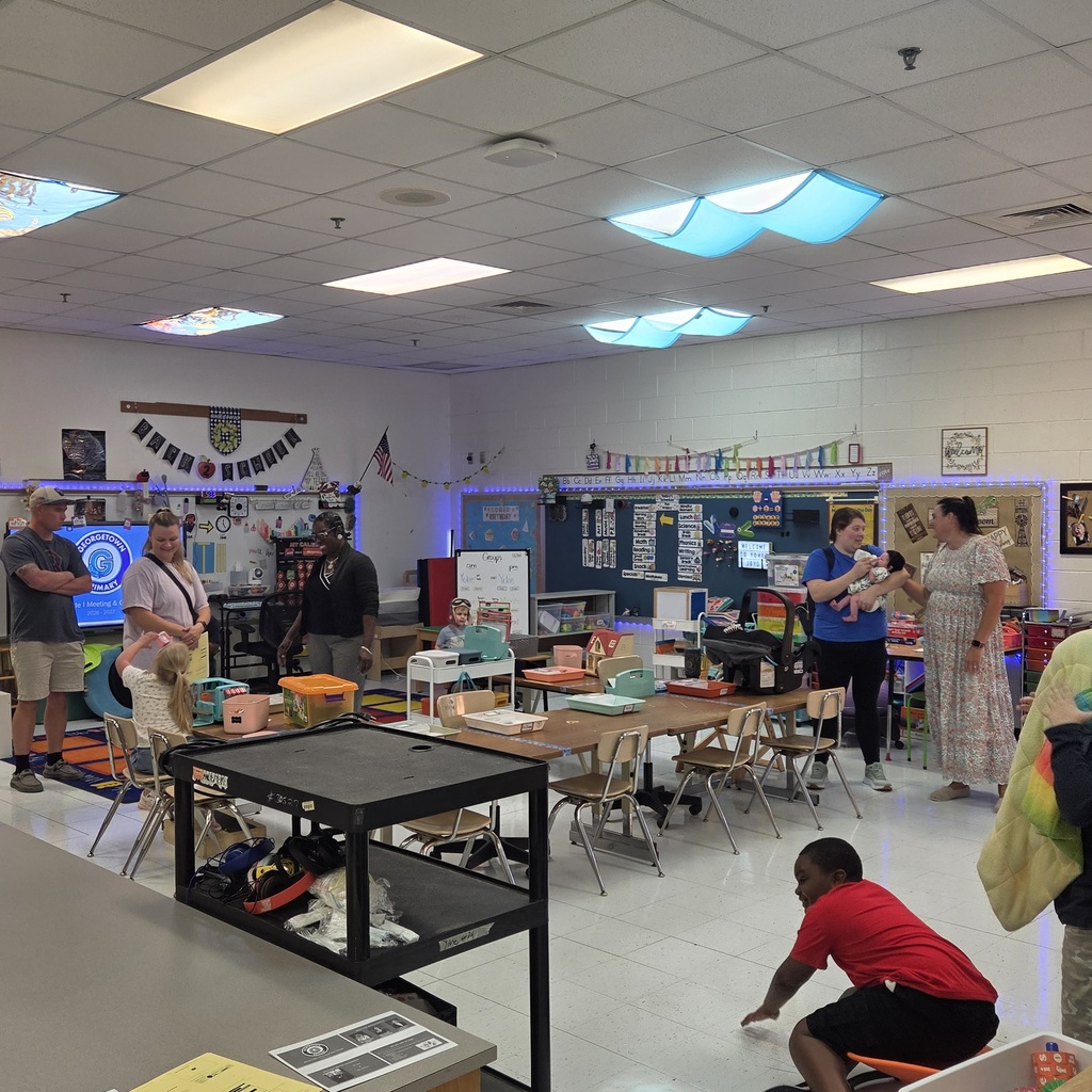 parents and students speak with teachers before their open house presentation