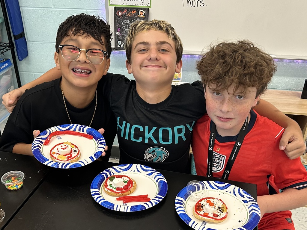 students smiling with the cookie cell creations