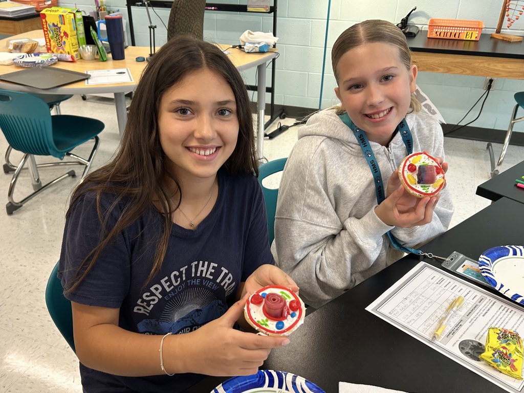 students smiling with the cookie cell creations