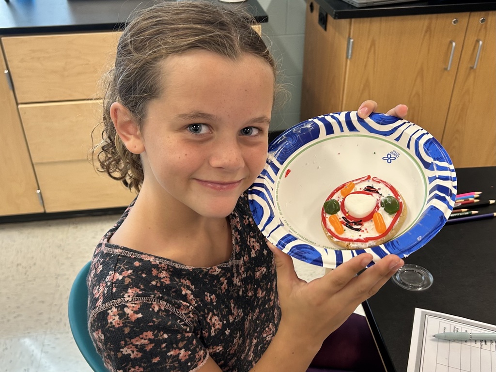 student smiling with the cookie cell creations