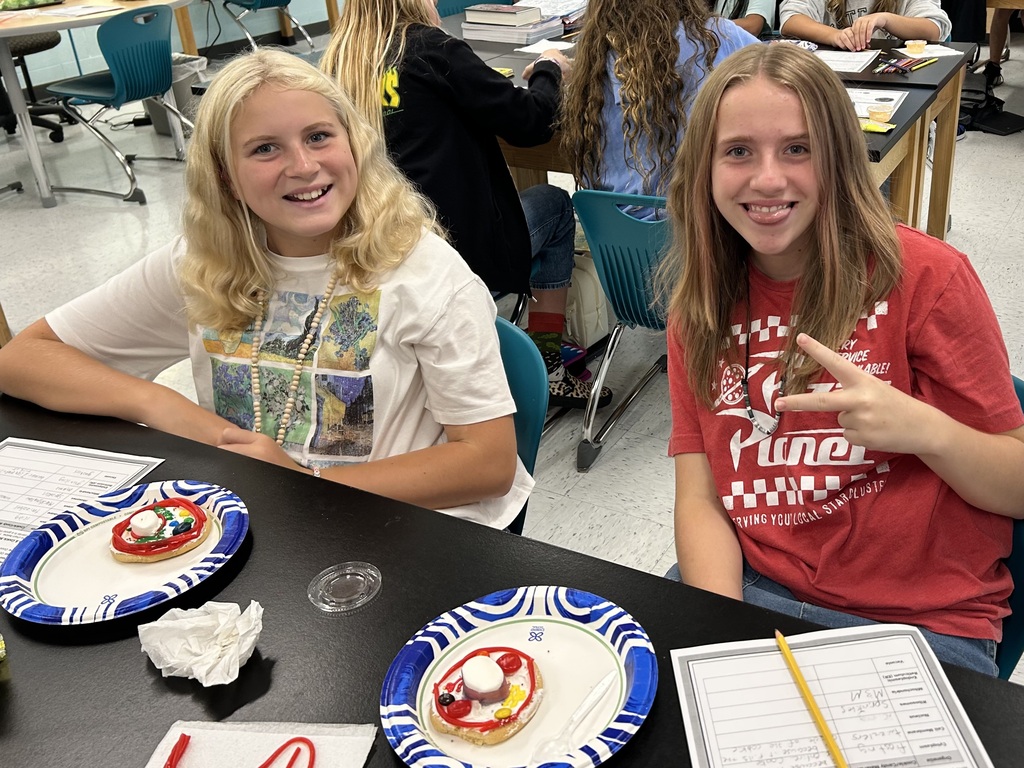 students smiling with the cookie cell creations