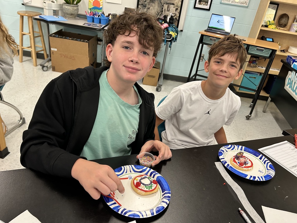 students smiling with the cookie cell creations