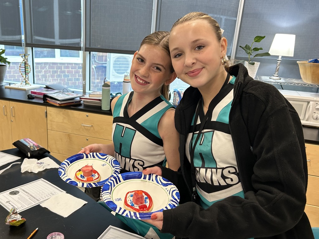 students smiling with the cookie cell creations