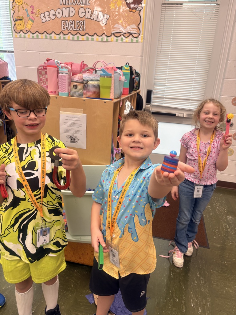 Students showing their magnetic items they found during their magnet exploration.