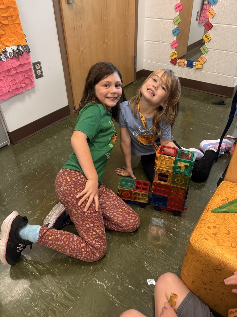 Two of Ms. Shinn's students posing proudly next to their magnatile masterpiece.