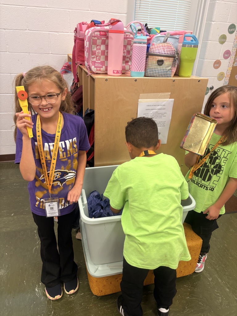 Group of students showing of their findings from the bin of magnets