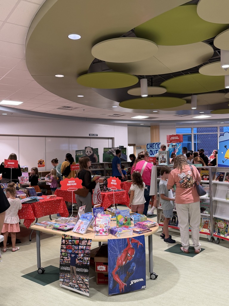 Students and parents excitedly shopping at the book fair during Open House.