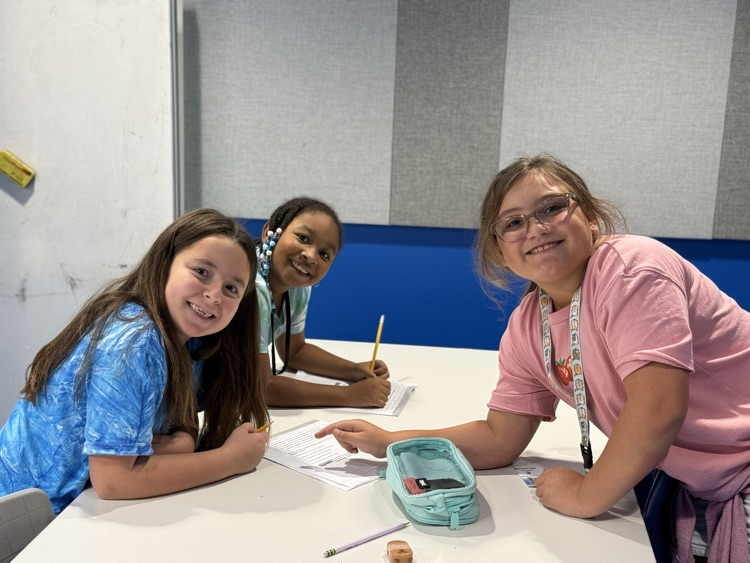 student smiling working in a group