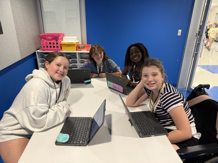 student smiling working in a group