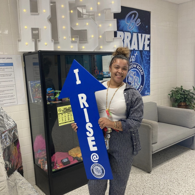 Ms. Gilliam holding the I RISE arrow in the main lobby. 