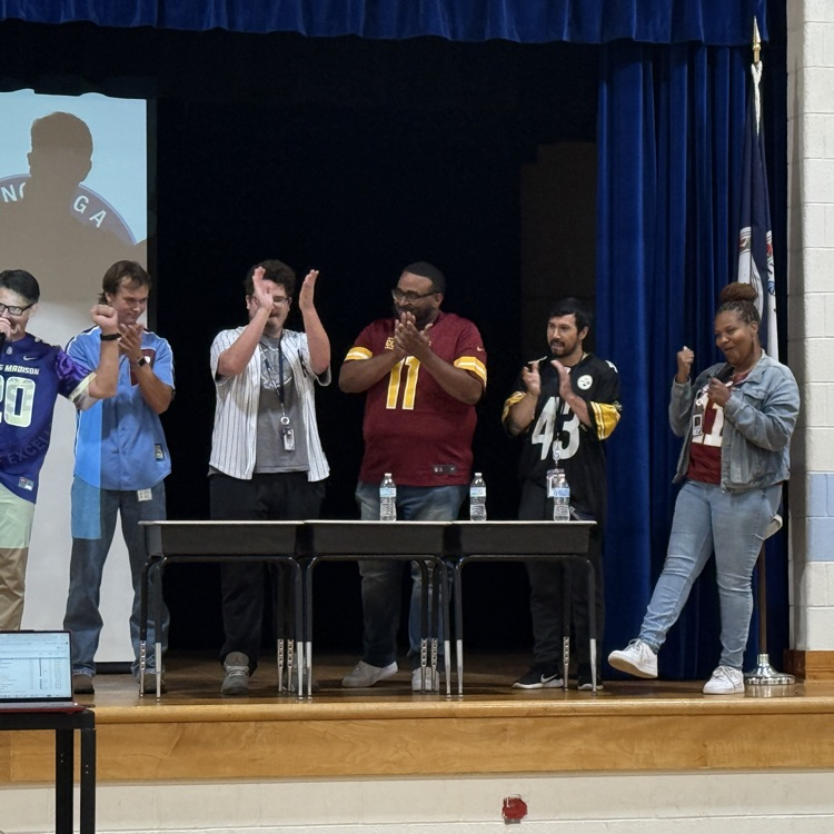 Teachers clapping when their total score was announced on stage. 