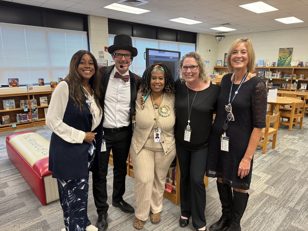 Ms. Alexander, Mr. Triolet, Mrs. Daniels, Mrs. Boyles, and Mrs. Boerboom standing together in the Media Center.