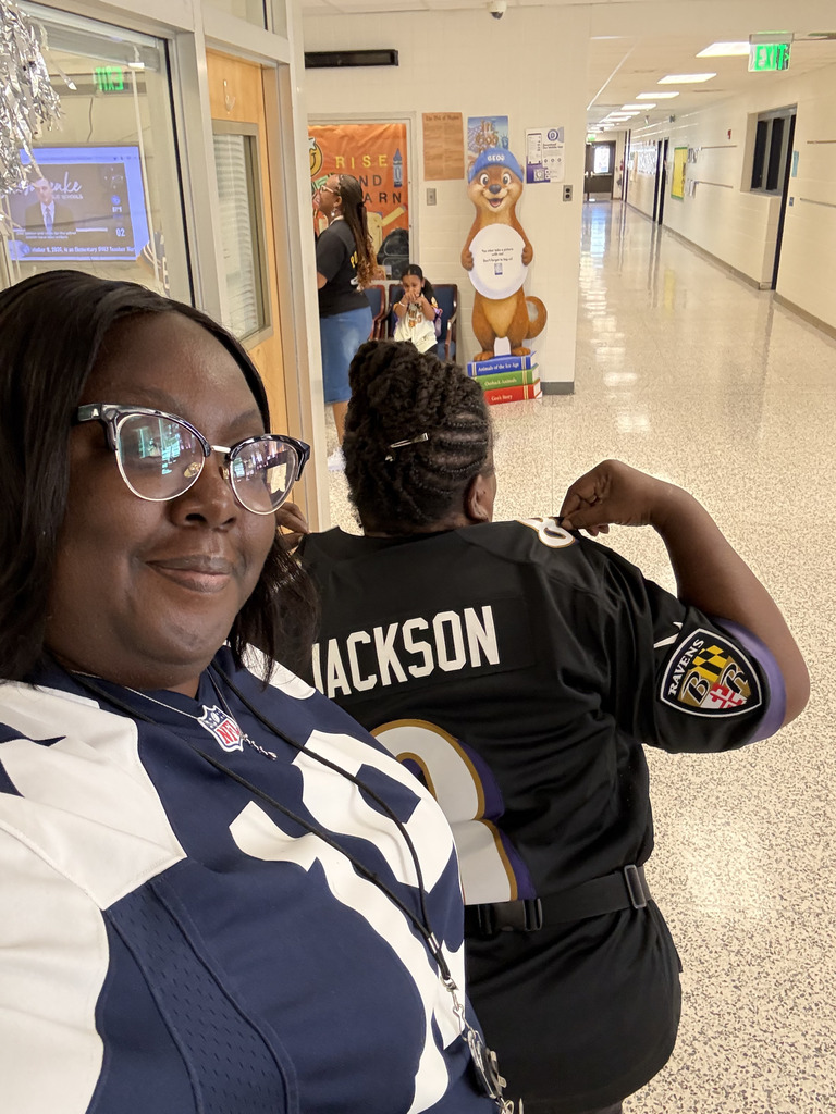 staff take a picture in their Dallas Cowoby and Baltimore Raven jersey