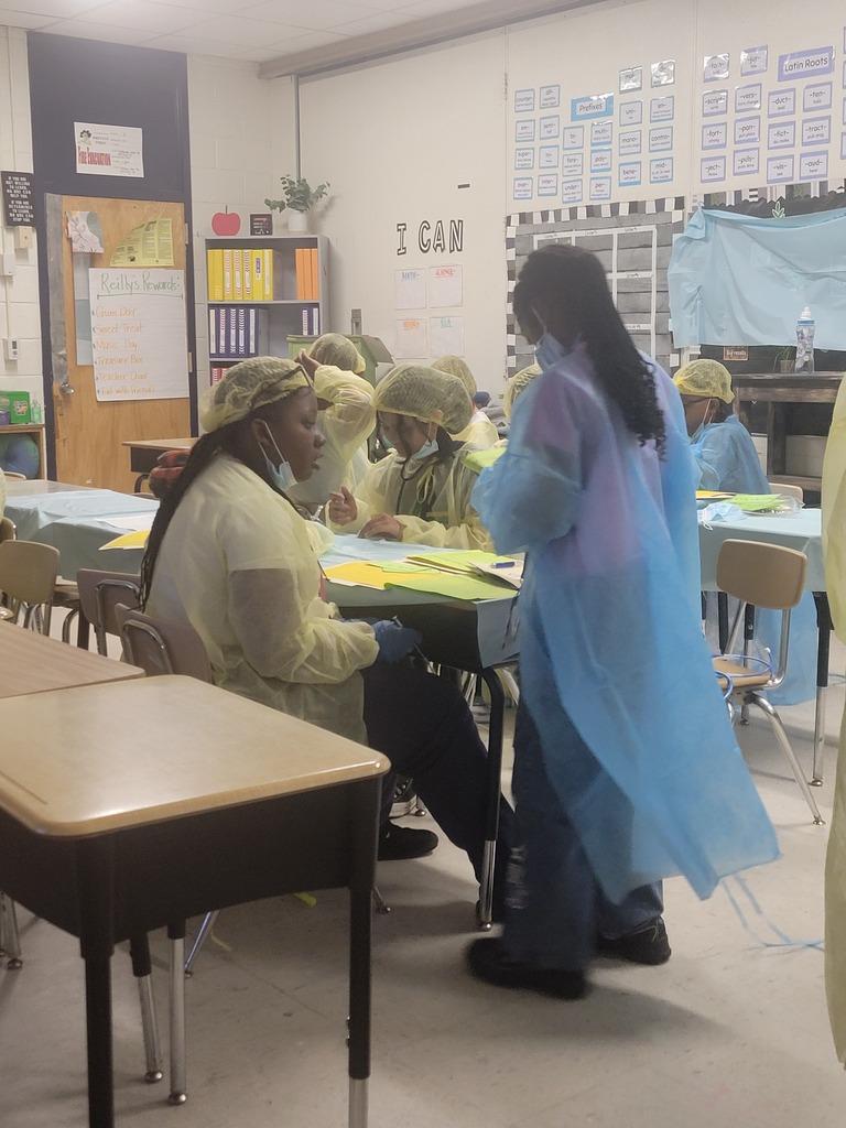 Students in scrubs doing order of operations
