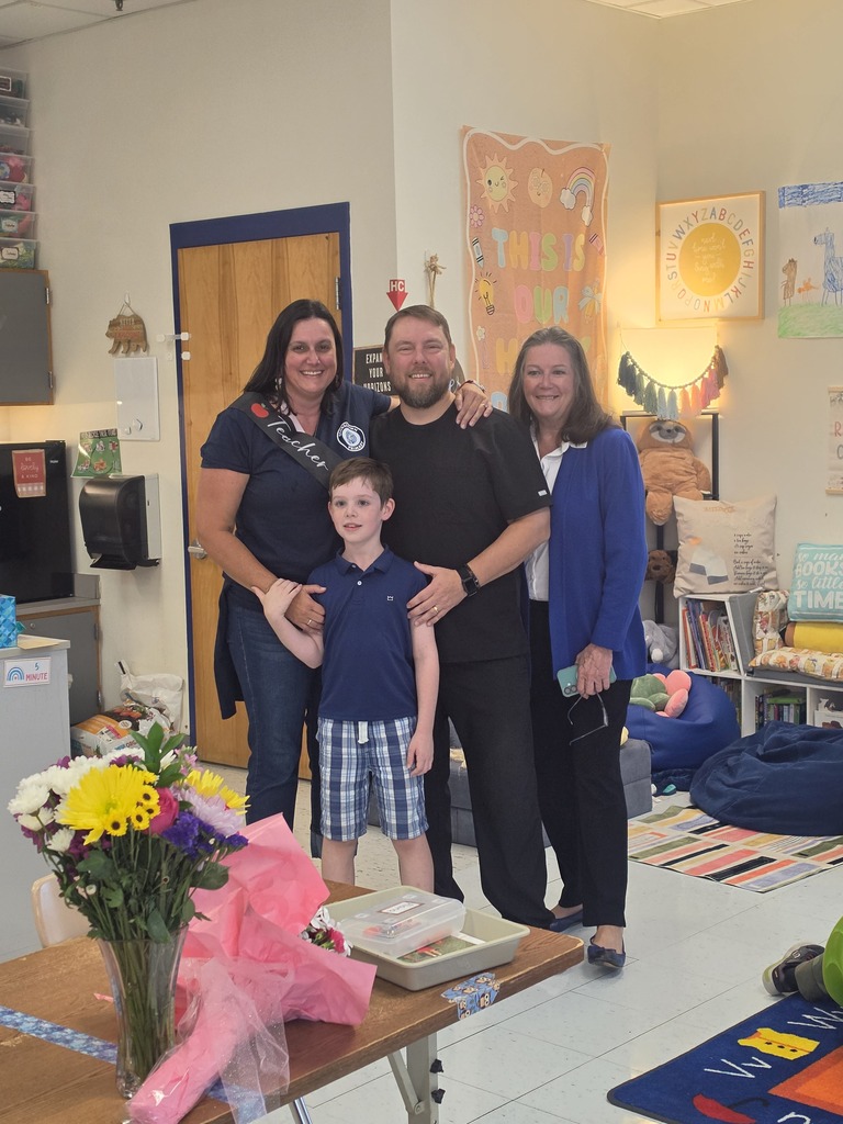 Mrs. Yohe and her family pose after she is named teacher of the year