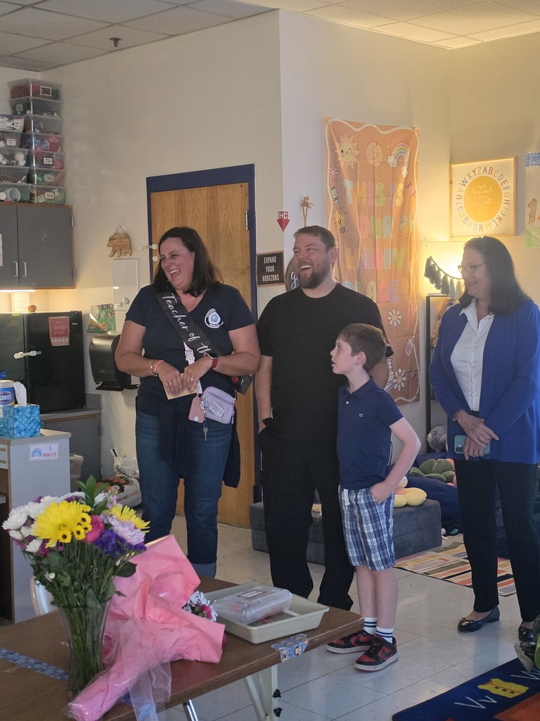 Mrs. Yohe and her family laughing as they celebrate her being revealed as teacher of the year