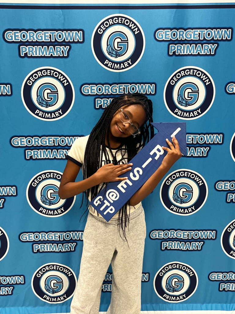 student posing with I RISE arrow after receiving positive office referral