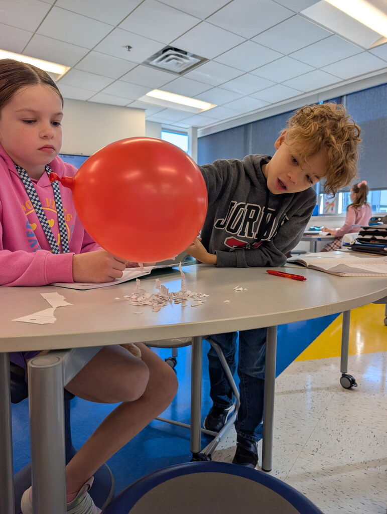 5th grade working on static electricity with balloons
