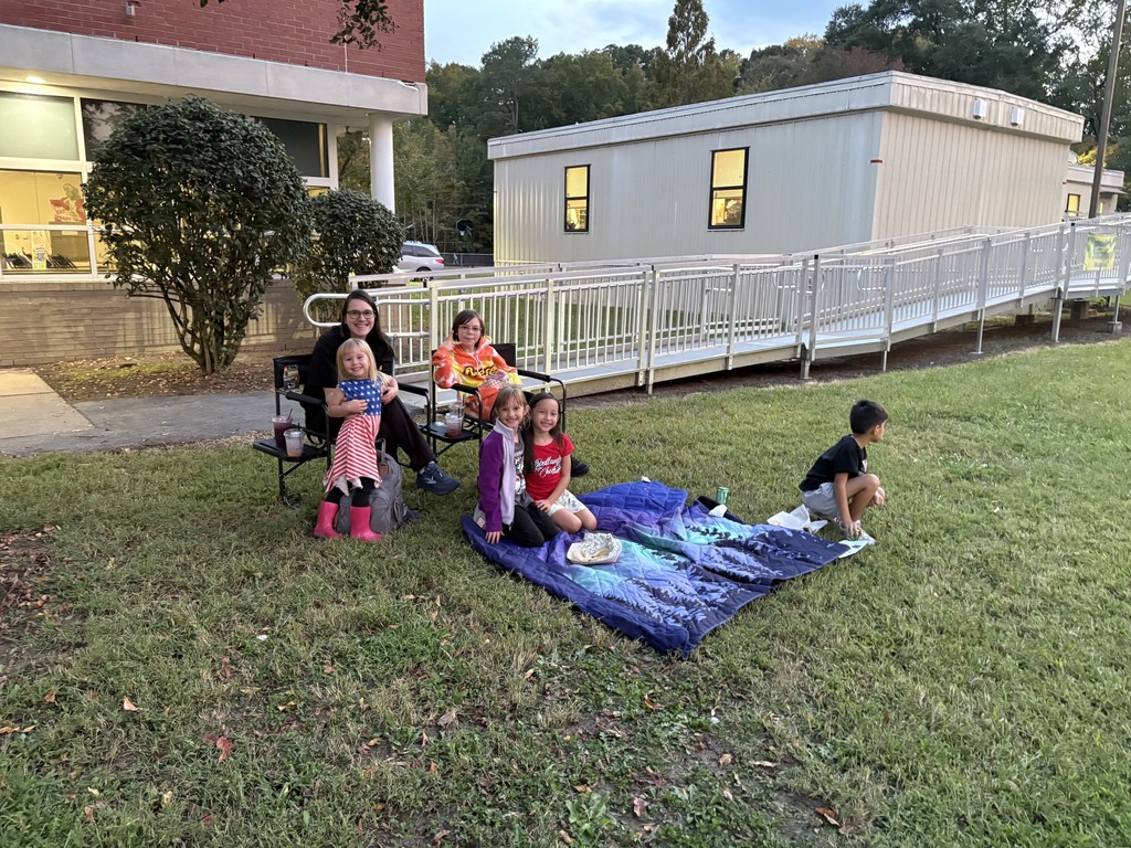 family enjoying dinner on the lawn