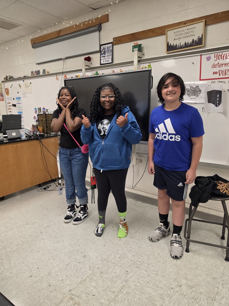 three students wearing a their crazy socks