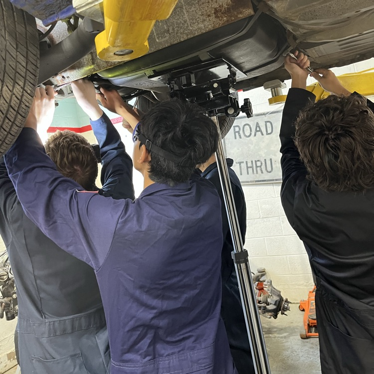 auto tech 1 students working on an engine
