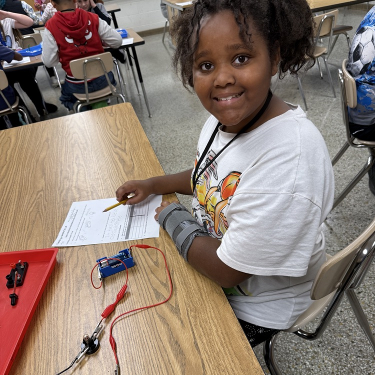 student smiling with completed circuit.