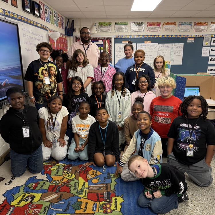 Class picture of Mr. Goldens class and the feather of honor.